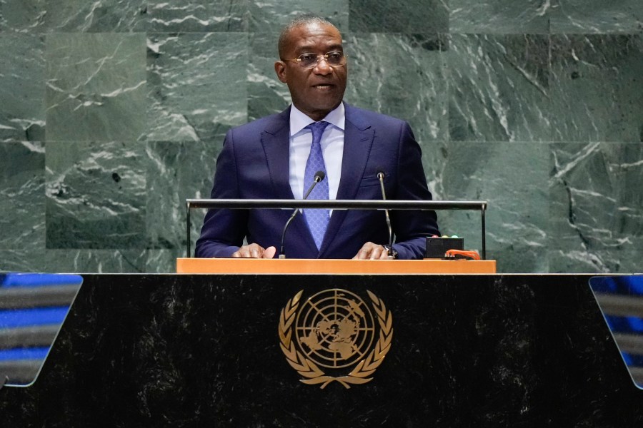 A man in a suit and tie at a podium.