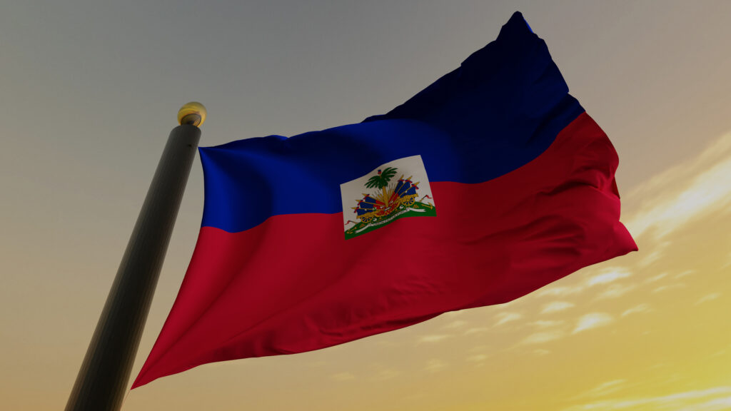 A flag of haiti is flying in the wind.