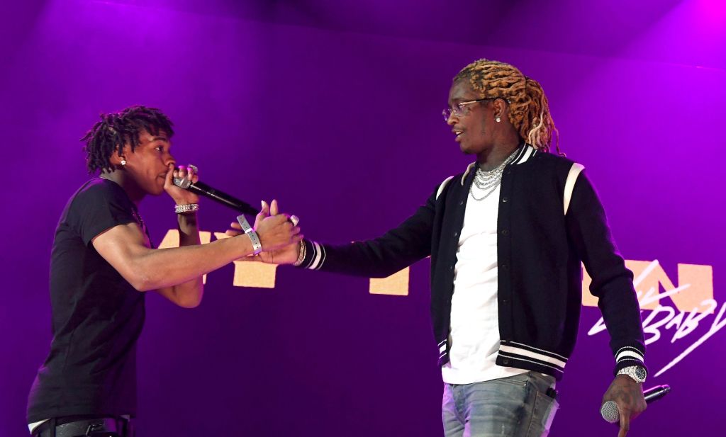 A man and woman shaking hands on stage.