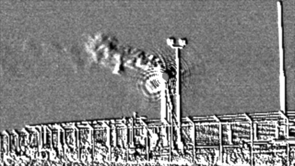 A black and white photo of smoke coming out from the top of a building.