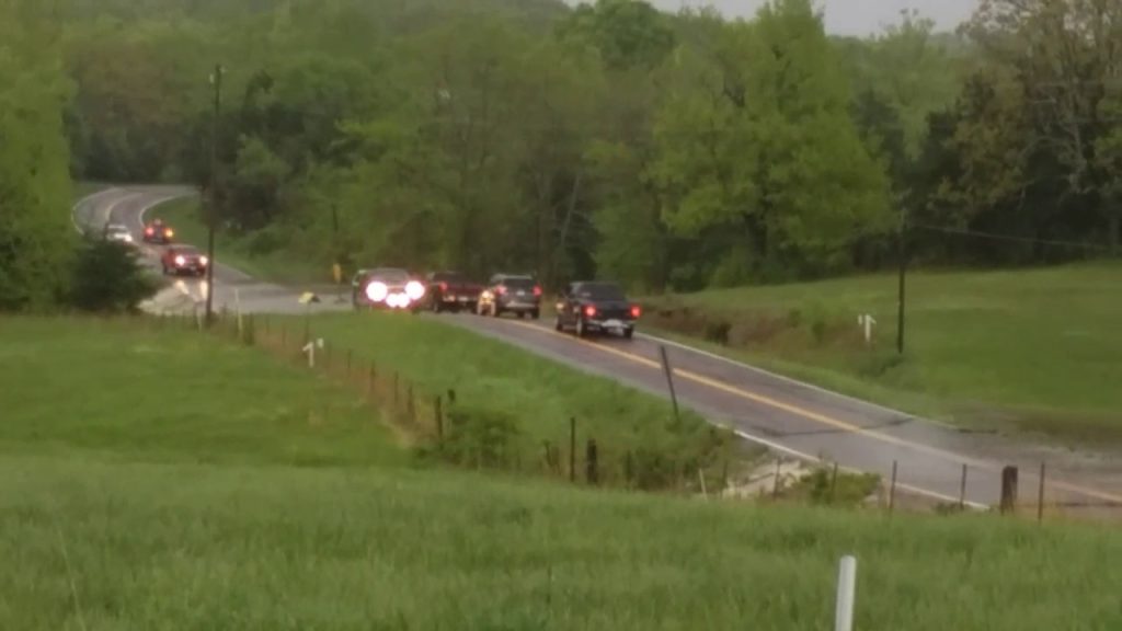 A group of cars driving down the road.