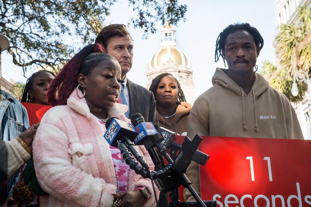 A group of people standing around a microphone.