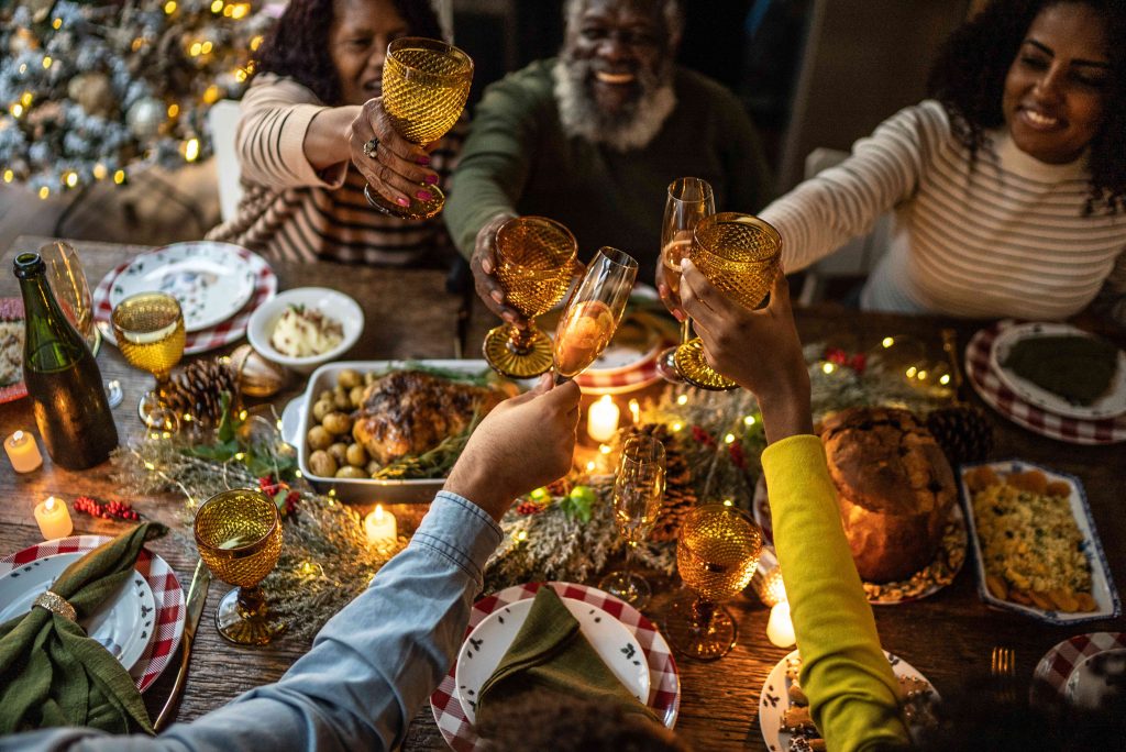 A group of people sitting around a table with food.