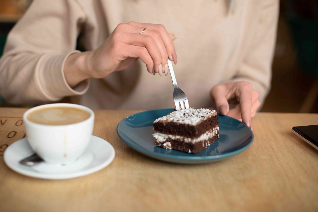 A person cutting into a piece of cake.