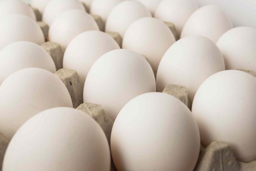 A close up of many eggs in a carton