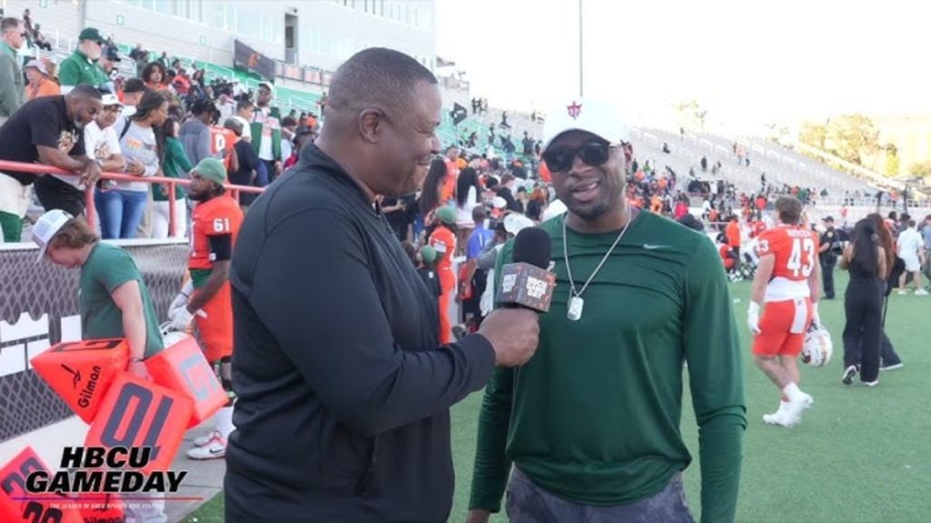 A man is being interviewed by an announcer.