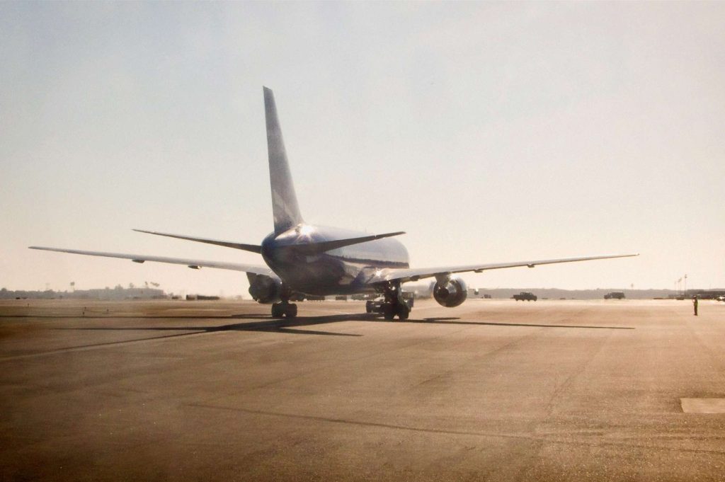 A large airplane on the runway of an airport.