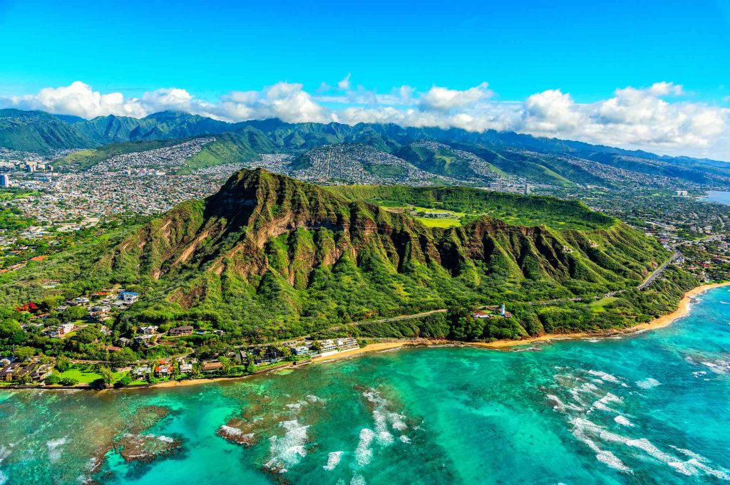 A view of the ocean and mountains from above.