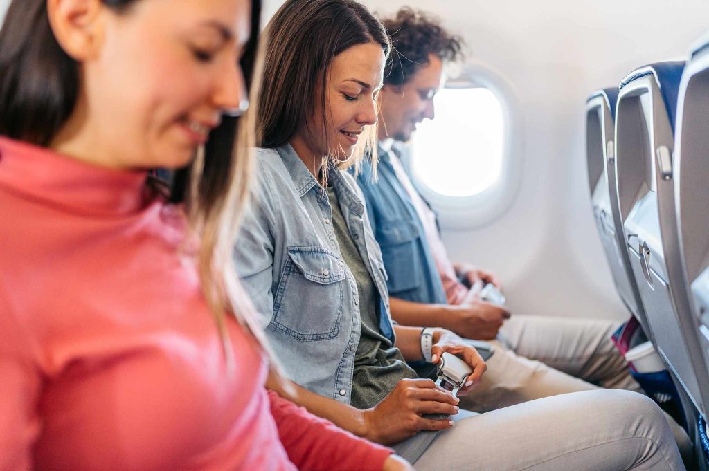 A group of people sitting on top of an airplane.