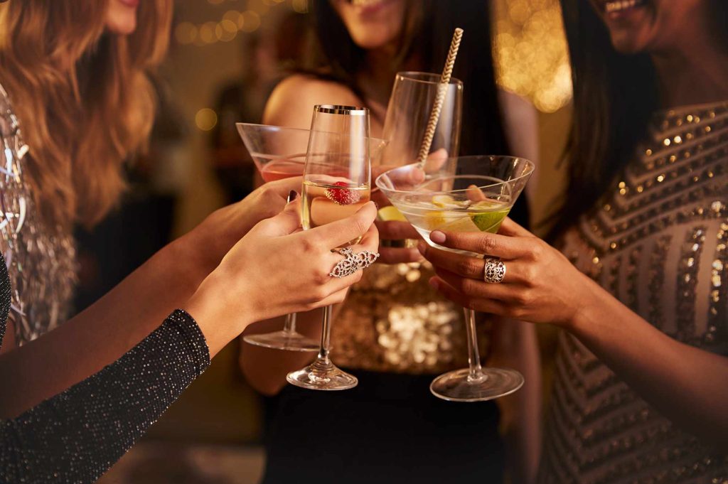 A group of people holding wine glasses in their hands.