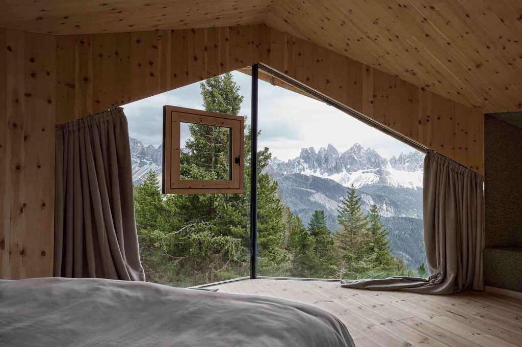 A bedroom with a view of the mountains