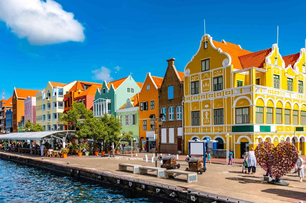 A row of colorful buildings next to the water.