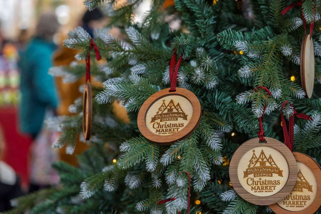 A christmas tree with wooden ornaments hanging from it.