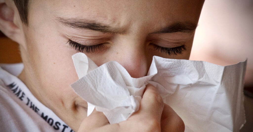 A person with a tissue in their hand