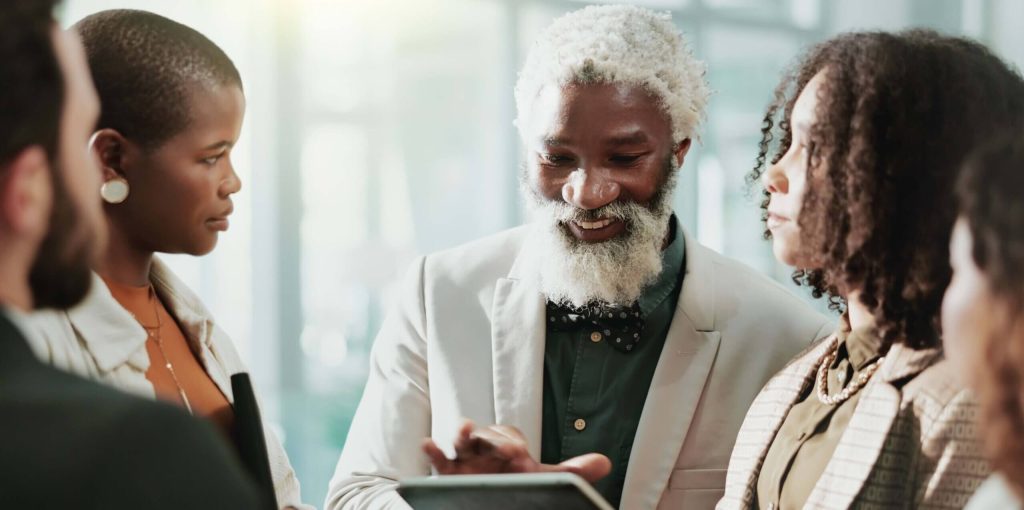 A man with a beard is looking at his tablet.