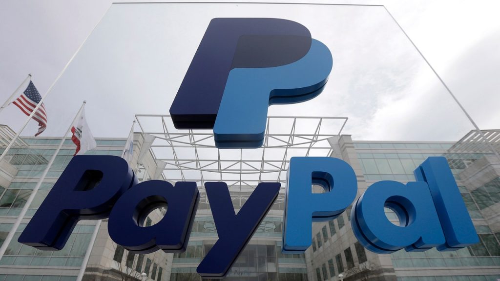 A paypal sign is shown in front of a building.