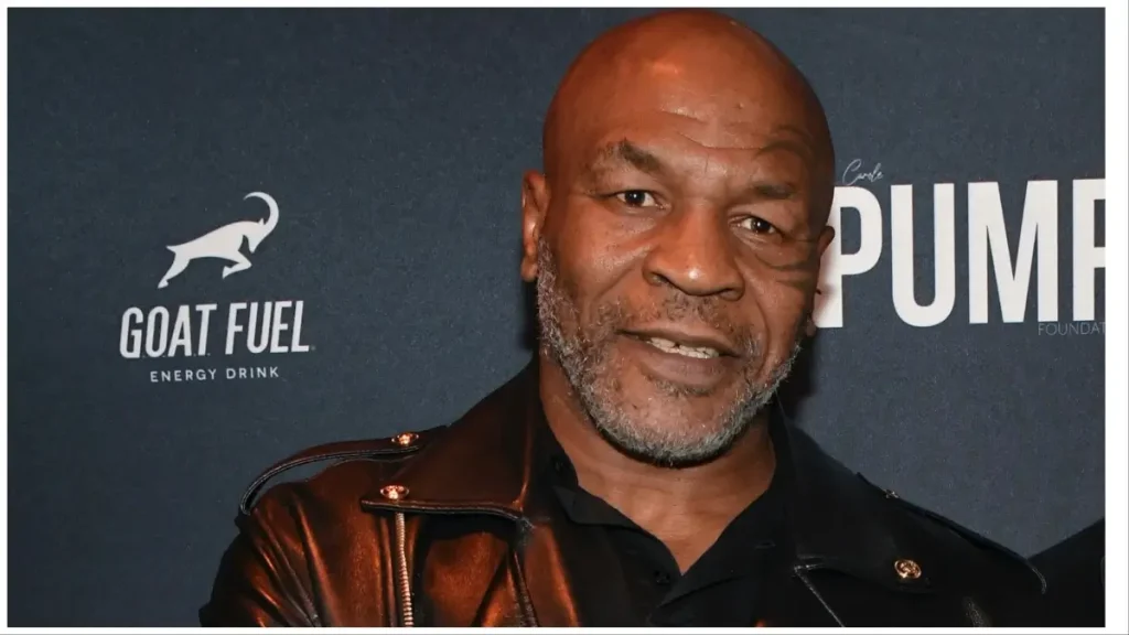 A close up of mike tyson wearing a leather jacket