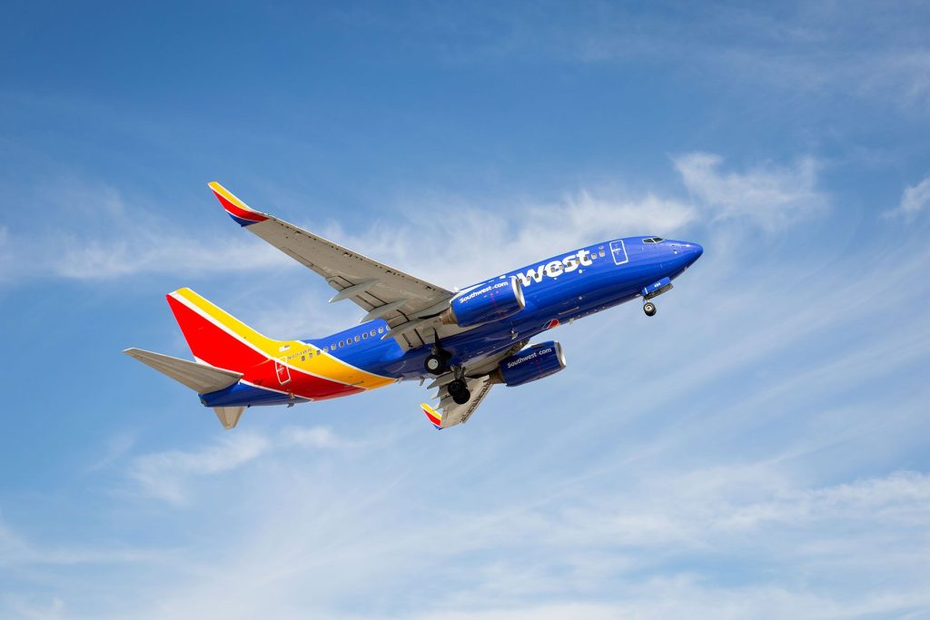 A southwest airlines plane flying in the sky.