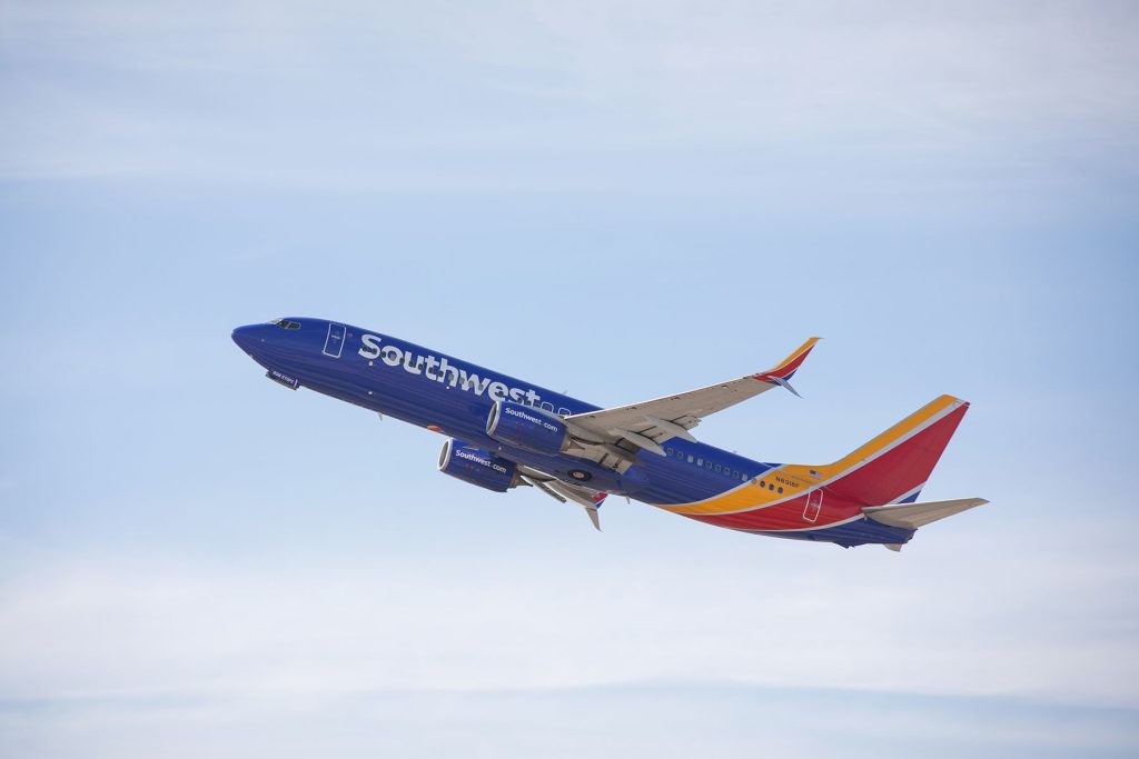 A southwest airlines airplane flying in the sky.