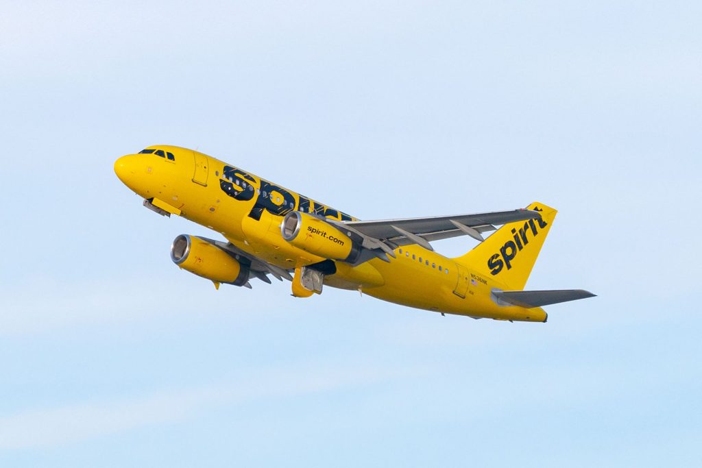 A yellow airplane flying in the sky.