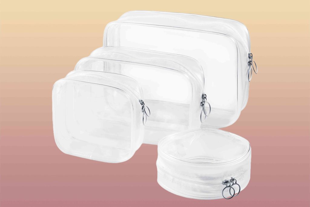 A set of four clear bags sitting on top of each other.