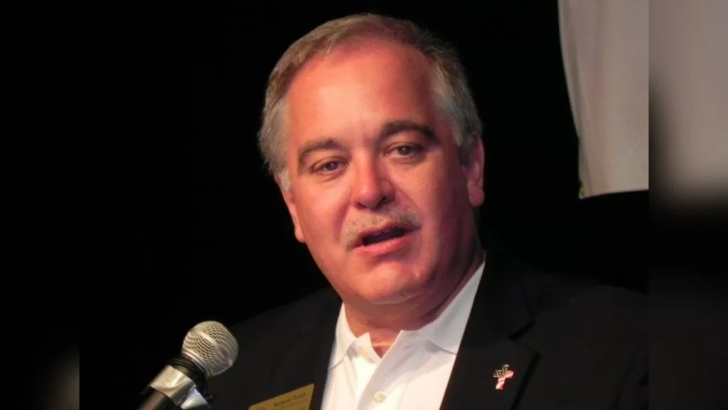 A man with a microphone in front of a microphone.