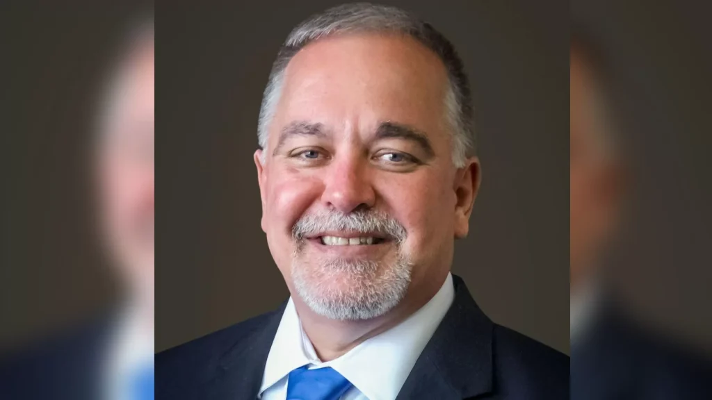 A man with a beard and mustache wearing a suit.