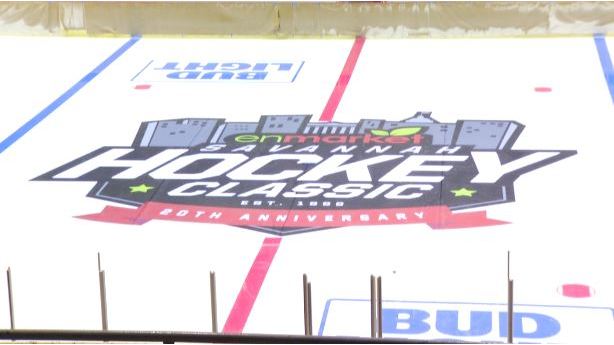 A close up of the logo on a hockey rink.