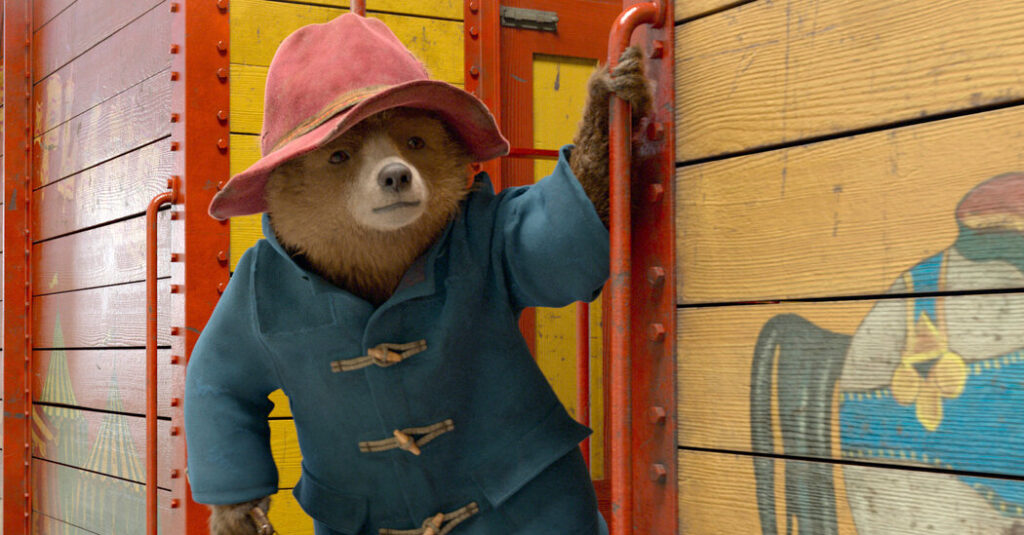 A bear in a red hat and blue coat