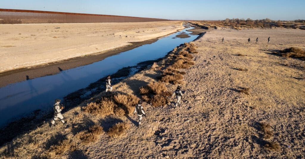 A dirt road with water running through it.
