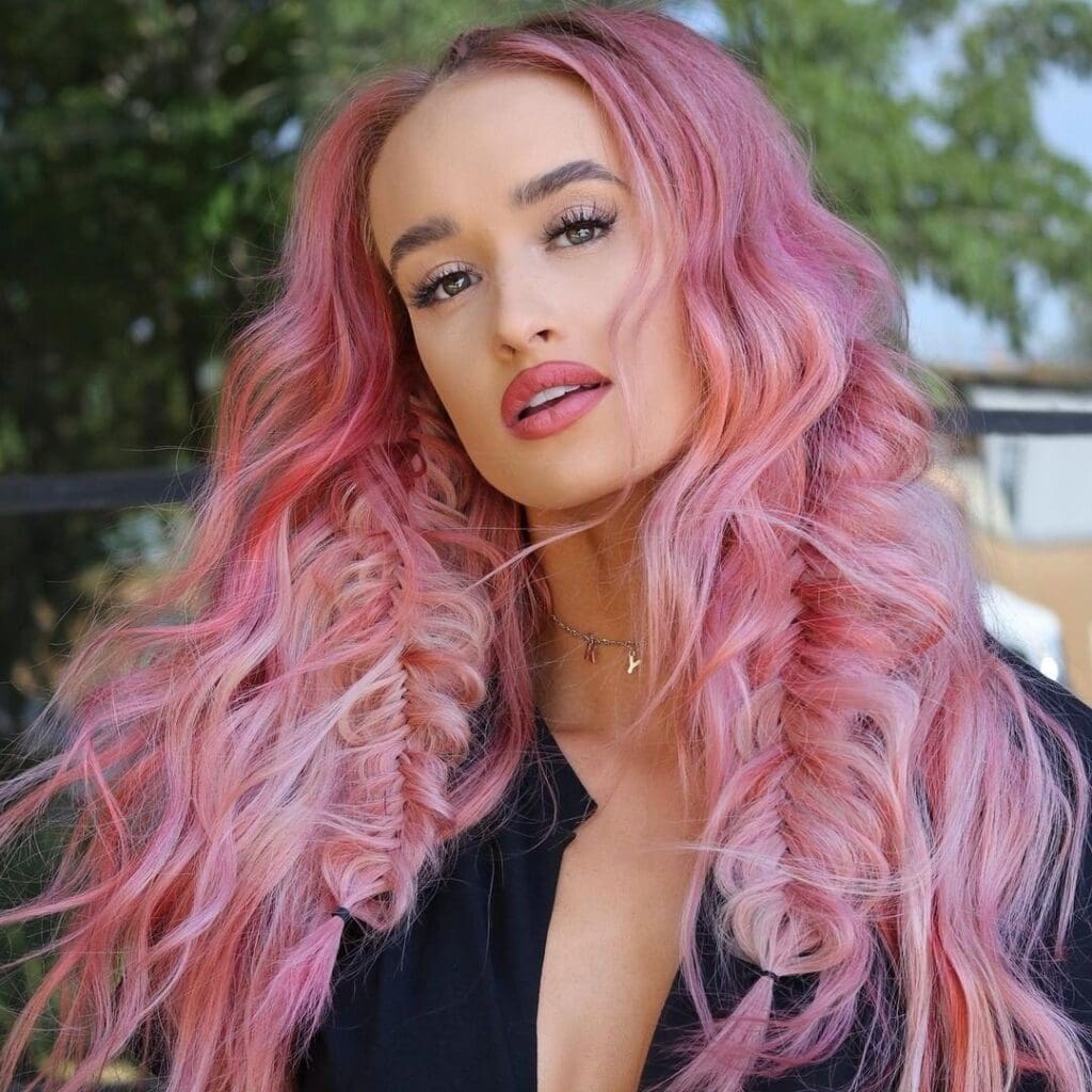A woman with pink hair and wearing black.