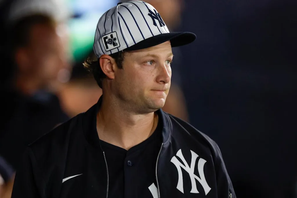 A baseball player wearing a yankees hat.