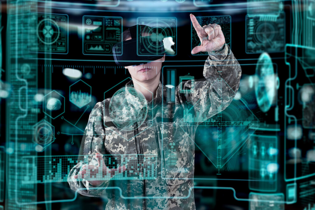 A soldier in camouflage is using a virtual reality headset.