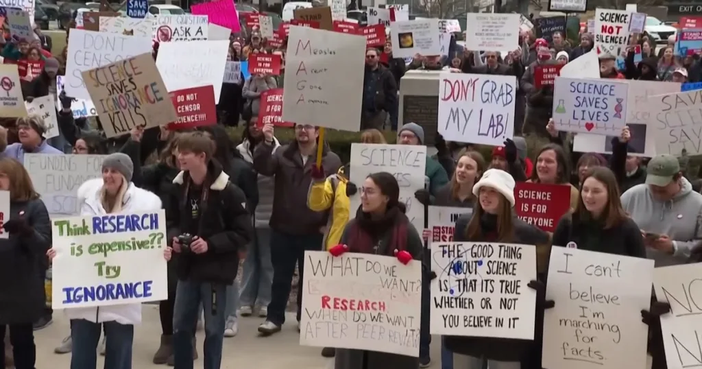 A crowd of people protesting in the street.