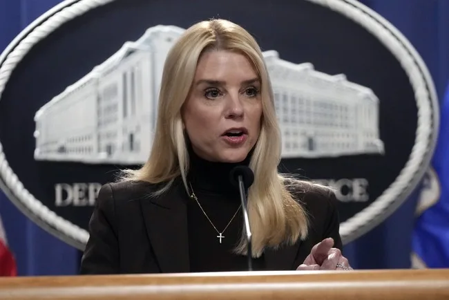 A woman in black jacket standing at a podium.