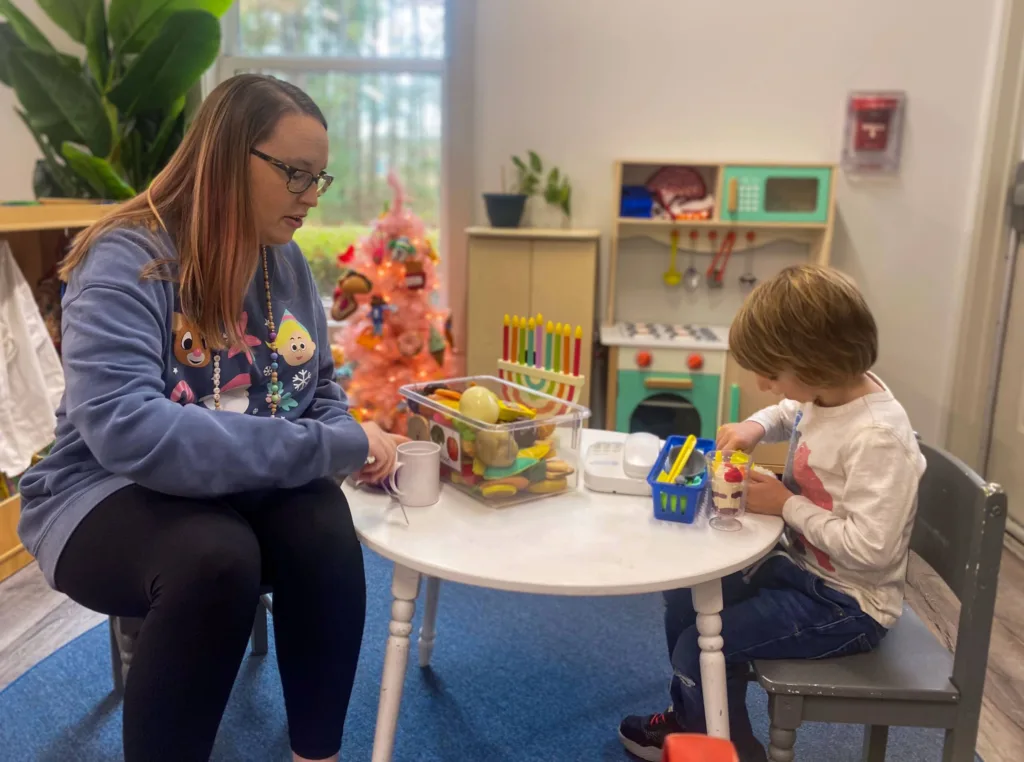 A woman and child sitting at a table