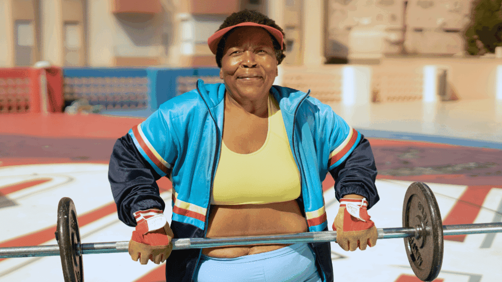 Senior Black woman weightlifting outdoors