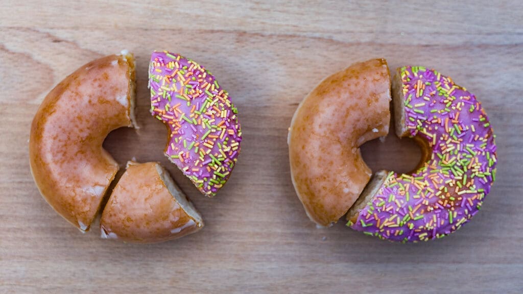 One Easy Means to Improve at Analysis Information Two donuts, sliced and sprinkled, on wood.