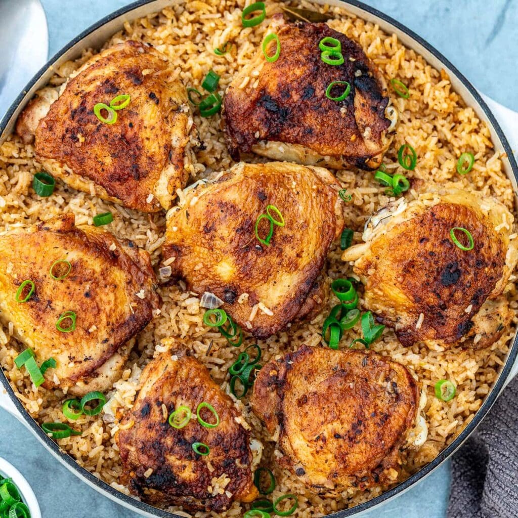 Baked chicken thighs on seasoned rice.
