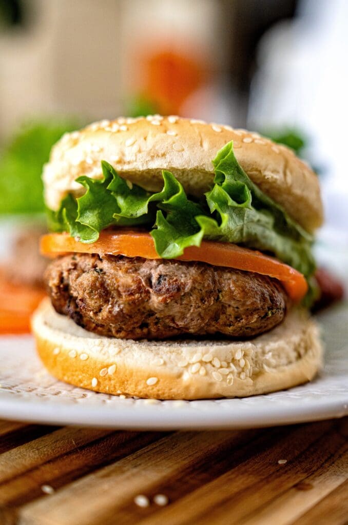 Juicy Turkey Burgers (Stove & Air Fryer) Juicy burger with lettuce and tomato.