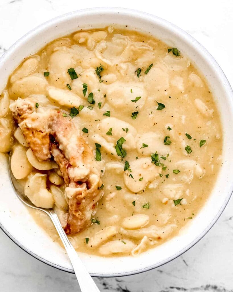 Bowl of finished beans with spoon in it.