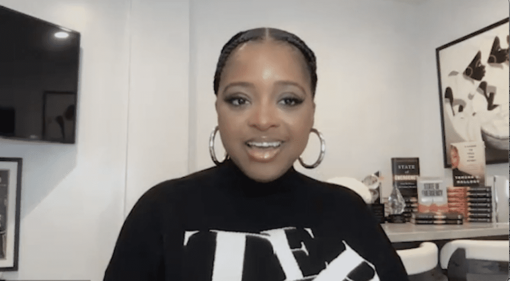 Smiling woman in a modern office setting.