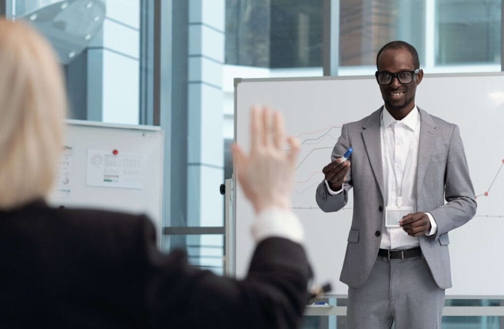 Black man in a suit answering questions at a tech conference