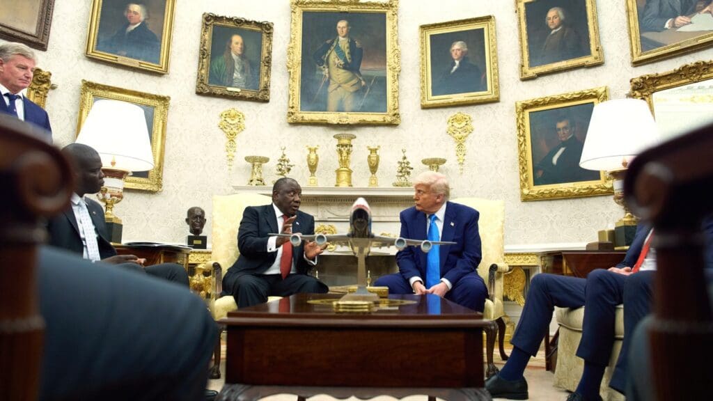Meeting in a room with historic portraits.