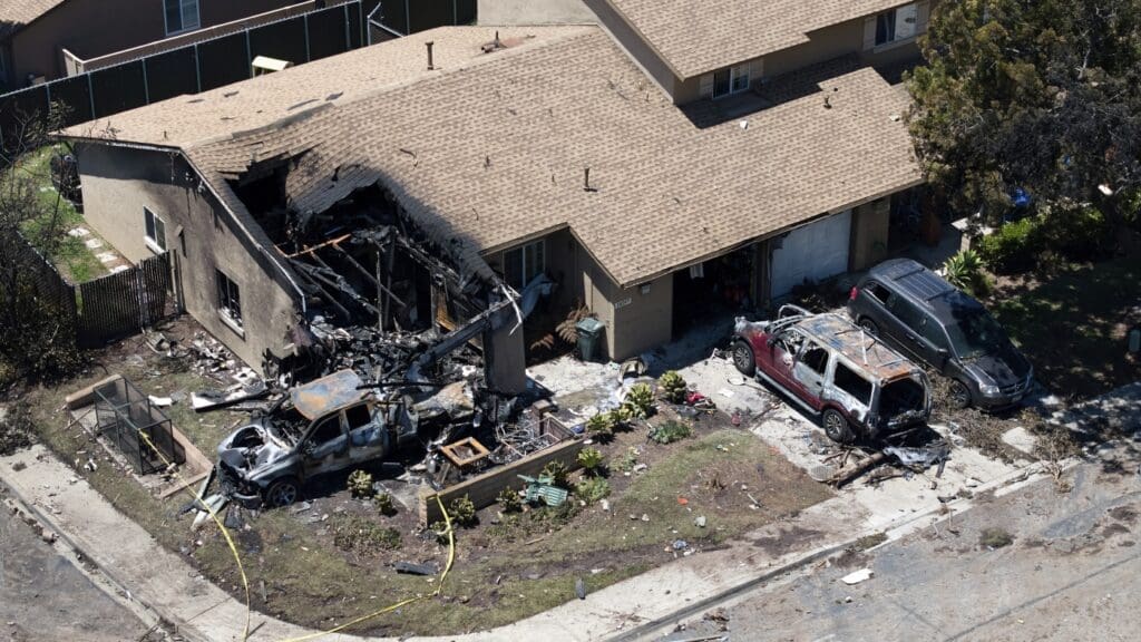 House and vehicles damaged by fire.