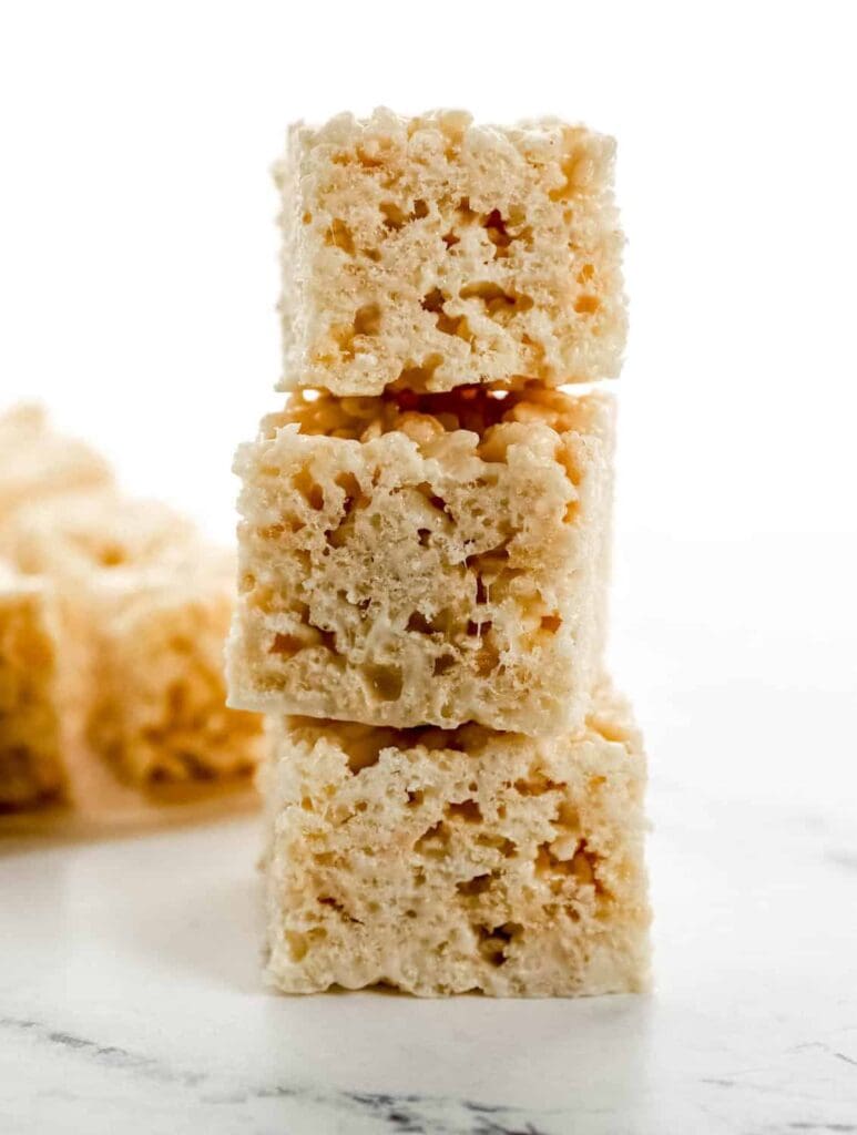 Gooey Rice Krispie Treats (Delicate, Chewy & Further Marshmallowy!) Close up side view of rice krispie treats stacked on top of each other.