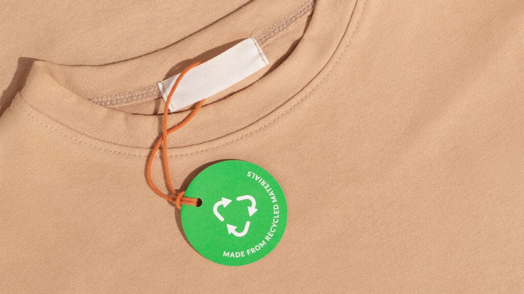 Beige shirt with recycled materials tag.