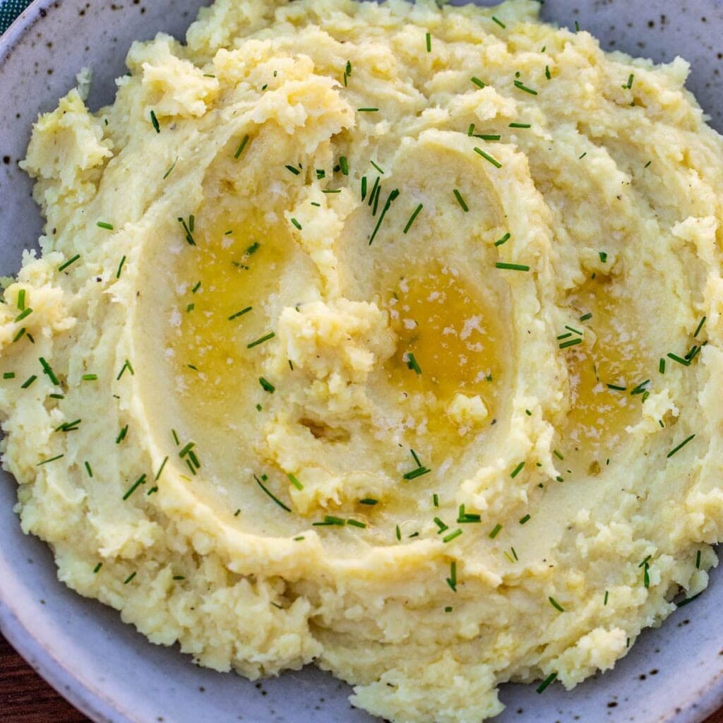 Creamy mashed potatoes garnished with chives.