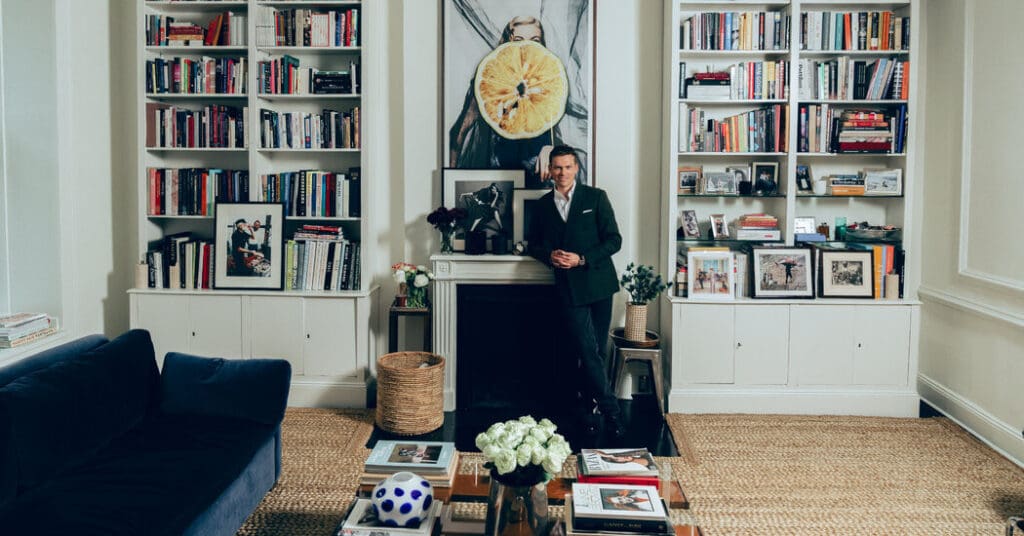 Man standing in stylish living room library.
