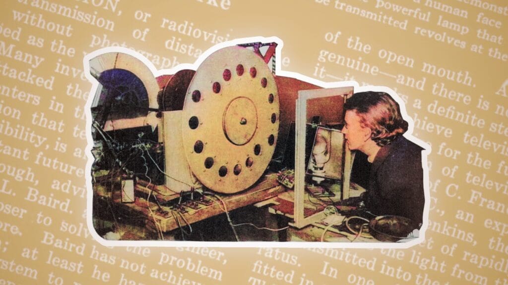 text in the background, a man sitting at the first tv in foreground